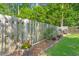 Backyard featuring wood fence with flowering shrubs, plants and mulch, offers privacy and visual interest at 3364 Middlesboro Ave, Summerville, SC 29485