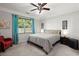 Comfortable bedroom with plush carpeting, ceiling fan, and window overlooking a lush yard at 3364 Middlesboro Ave, Summerville, SC 29485