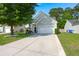 Inviting home with a long driveway, attached garage, and a well-kept front yard and landscaping at 3364 Middlesboro Ave, Summerville, SC 29485
