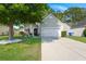 Beautiful home featuring a lush green lawn, a tree providing shade, and a two-car garage at 3364 Middlesboro Ave, Summerville, SC 29485