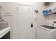 Bright laundry room features modern washer and dryer, storage shelves, and convenient access to the outdoors at 3364 Middlesboro Ave, Summerville, SC 29485