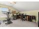 Functional home office space with multiple desks, a computer setup, and exercise equipment at 3364 Middlesboro Ave, Summerville, SC 29485