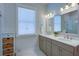 Light filled bathroom with dual sinks, large mirror, shaker cabinets and wicker basket storage at 3539 Habenaria Rd # 28, Mount Pleasant, SC 29466