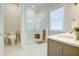 Bright bathroom featuring glass enclosed shower, toilet, sink, and vanity with wicker basket storage at 3539 Habenaria Rd # 28, Mount Pleasant, SC 29466