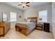 Cozy bedroom with a wooden bed, ceiling fan, and lots of natural light at 3539 Habenaria Rd # 28, Mount Pleasant, SC 29466