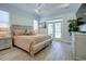 This primary bedroom features tray ceilings, wood-look floors and french doors to back yard at 3539 Habenaria Rd # 28, Mount Pleasant, SC 29466