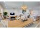 Elegant dining area with a wooden table, decorative light fixture, and open view to the living spaces at 3539 Habenaria Rd # 28, Mount Pleasant, SC 29466