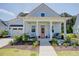 Charming home featuring a quaint covered porch with stylish seating and a well-manicured front yard at 3539 Habenaria Rd # 28, Mount Pleasant, SC 29466
