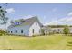 Spacious home with light blue siding, a dark roof, manicured lawn and mature landscaping on a sunny day at 3539 Habenaria Rd # 28, Mount Pleasant, SC 29466