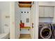 Mudroom with hooks, bench, and barn door leading to laundry room with blue washer and dryer at 3539 Habenaria Rd # 28, Mount Pleasant, SC 29466