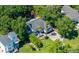 Aerial view of the house nestled among lush trees with a well-manicured lawn and long driveway at 3872 James Bay Road Rd, Johns Island, SC 29455