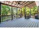 This covered back porch features a vaulted ceiling, ceiling fan, and a picturesque view of the backyard at 3872 James Bay Road Rd, Johns Island, SC 29455