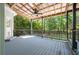 This covered back porch features a vaulted ceiling, ceiling fan, and a picturesque view of the backyard at 3872 James Bay Road Rd, Johns Island, SC 29455