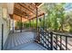 This covered back porch features a vaulted ceiling, ceiling fan, and stairs leading to the backyard at 3872 James Bay Road Rd, Johns Island, SC 29455