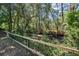 View of lush backyard with serene creek and wooden fence at 3872 James Bay Road Rd, Johns Island, SC 29455
