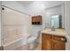 Well-lit bathroom with bathtub, toilet, and vanity with wooden cabinet storage at 3872 James Bay Road Rd, Johns Island, SC 29455