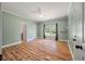 Spacious bedroom with hardwood floors, ceiling fan, and large window at 3872 James Bay Road Rd, Johns Island, SC 29455