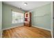 This bedroom features a wooden storage cabinet and large bright window with an Americana flag outside at 3872 James Bay Road Rd, Johns Island, SC 29455