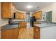 Bright kitchen with wooden cabinets, dark countertops, and modern appliances on wood floors at 3872 James Bay Road Rd, Johns Island, SC 29455
