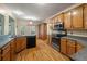 Bright kitchen with stainless appliances, wooden cabinets, and a sink overlooking the back porch at 3872 James Bay Road Rd, Johns Island, SC 29455