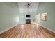 Bright living room with hardwood floors, a fireplace, high ceilings, and a ceiling fan at 3872 James Bay Road Rd, Johns Island, SC 29455