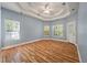 Spacious main bedroom with a tray ceiling, hardwood floors, and natural light at 3872 James Bay Road Rd, Johns Island, SC 29455