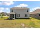 View of the home's backyard, featuring a screened-in porch and a spacious lawn at 411 Bering Ln, Summerville, SC 29486