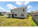 Backyard view of the home, highlighting the screened-in porch and ample lawn space at 411 Bering Ln, Summerville, SC 29486