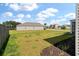 The home's backyard features a spacious lawn, a neighboring fence, and surrounding houses at 411 Bering Ln, Summerville, SC 29486