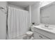 A well-lit bathroom with a shower curtain, standard toilet, vanity with storage, and neutral wall paint at 411 Bering Ln, Summerville, SC 29486