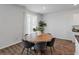 Dining area features a round wooden table with seating for six and natural light at 411 Bering Ln, Summerville, SC 29486