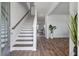 Bright entryway with wood-look flooring, stairs, and natural light at 411 Bering Ln, Summerville, SC 29486