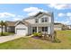 Charming two-story home featuring a well-manicured lawn, landscaping and attached two-car garage at 411 Bering Ln, Summerville, SC 29486