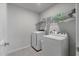 A convenient laundry room featuring a modern washer and dryer with extra storage on the racks at 411 Bering Ln, Summerville, SC 29486