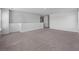 Large living room with neutral paint, carpeted floors, large windows, and open access to the upstairs rooms at 411 Bering Ln, Summerville, SC 29486