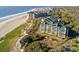 Aerial view showcases condo buildings along a sandy beach shoreline at 4209 Ocean Club Dr, Isle of Palms, SC 29451