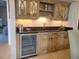 A stylish bar area featuring a wine cooler, granite countertops, and ample storage at 4209 Ocean Club Dr, Isle of Palms, SC 29451