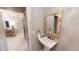 Elegant half bathroom featuring a pedestal sink and unique seashell-trimmed mirror at 4209 Ocean Club Dr, Isle of Palms, SC 29451