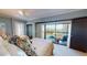Comfortable bedroom featuring two beds, balcony access, and stylish decor and furnishings at 4209 Ocean Club Dr, Isle of Palms, SC 29451