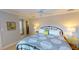 Comfortable bedroom with patterned duvet, decorative pillows and twin end table lamps at 4209 Ocean Club Dr, Isle of Palms, SC 29451