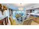 Light-filled dining room features a glass table, chandelier, and an open layout, perfect for entertaining at 4209 Ocean Club Dr, Isle of Palms, SC 29451