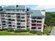 Exterior shot of condo building with private balconies overlooking landscaped grounds at 4209 Ocean Club Dr, Isle of Palms, SC 29451