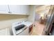 Bright laundry room featuring a modern washer, dryer, and white cabinets at 4209 Ocean Club Dr, Isle of Palms, SC 29451