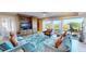 Cozy living room with plush seating, built-in shelving, and stunning views of the outdoors at 4209 Ocean Club Dr, Isle of Palms, SC 29451