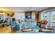 Open-concept living and dining area with large windows, shutters and a built-in entertainment center at 4209 Ocean Club Dr, Isle of Palms, SC 29451