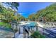 An outdoor pool with a fenced-in deck featuring lounge chairs and manicured landscaping at 4209 Ocean Club Dr, Isle of Palms, SC 29451