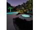 A beautiful pool and hot tub area at dusk surrounded by lush landscaping at 4209 Ocean Club Dr, Isle of Palms, SC 29451