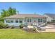 Backyard featuring a concrete patio with outdoor seating, manicured lawn, landscaping, and a well-maintained home exterior at 422 Cabrill Dr, Charleston, SC 29414