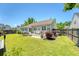 Backyard with a concrete patio featuring nice outdoor seating, a well-manicured lawn, and well-maintained home exterior at 422 Cabrill Dr, Charleston, SC 29414