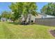 Spacious backyard features a green lawn, mature trees, and privacy fencing at 422 Cabrill Dr, Charleston, SC 29414